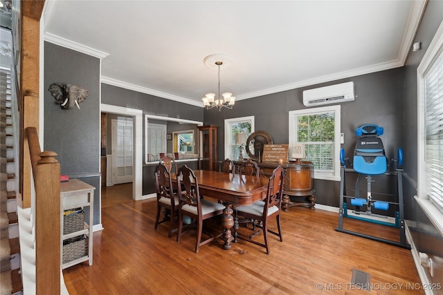 dining space featuring a notable chandelier, ornamental molding, visible vents, and a wall unit AC