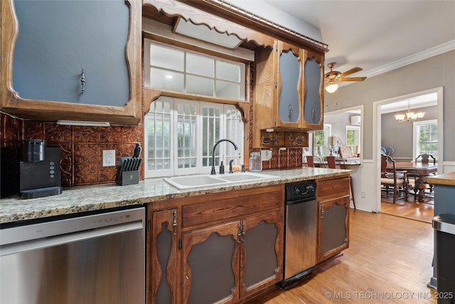 kitchen featuring a sink, ceiling fan with notable chandelier, decorative backsplash, light wood-type flooring, and dishwasher