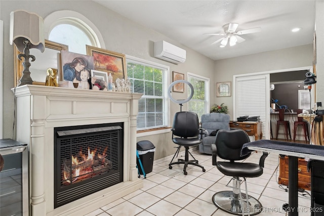 interior space featuring a ceiling fan, light tile patterned flooring, a healthy amount of sunlight, and a wall mounted air conditioner