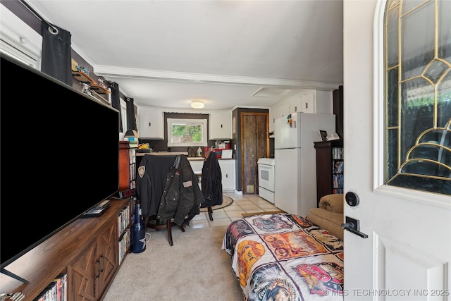 bedroom with light tile patterned floors and freestanding refrigerator