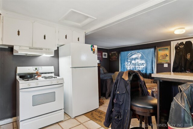 kitchen with white cabinets, white appliances, light countertops, under cabinet range hood, and light tile patterned floors