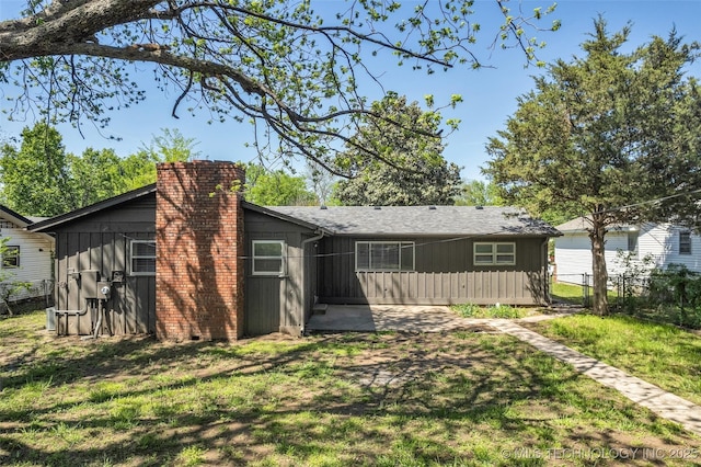507 W Quincy St, Broken Arrow, OK 74012 - back of property featuring board and batten siding and a chimney