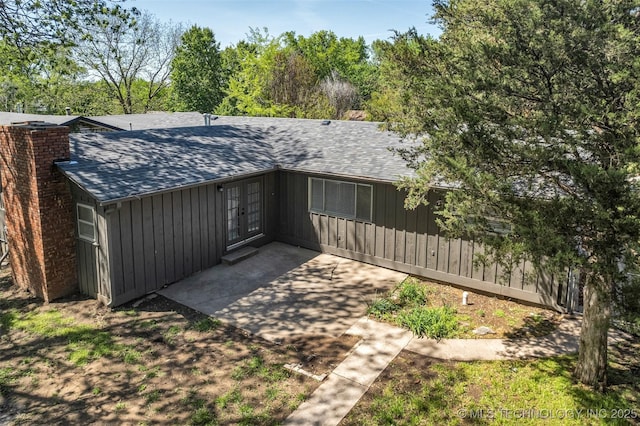 507 W Quincy St, Broken Arrow, OK 74012 - back of property featuring french doors, roof with shingles, a chimney, and board and batten siding