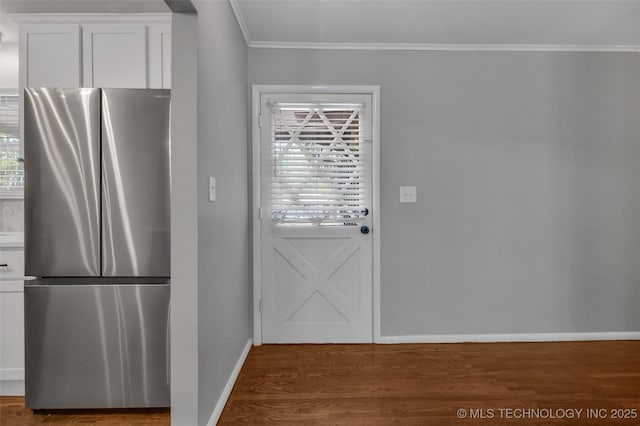 507 W Quincy St, Broken Arrow, OK 74012 - kitchen featuring freestanding refrigerator, baseboards, ornamental molding, wood finished floors, and white cabinets