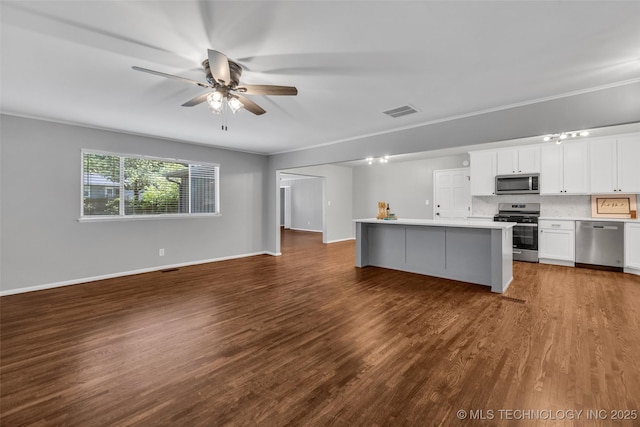 507 W Quincy St, Broken Arrow, OK 74012 - kitchen with stainless steel appliances, open floor plan, a ceiling fan, and dark wood-type flooring