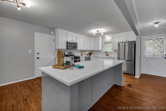 507 W Quincy St, Broken Arrow, OK 74012 - kitchen with stainless steel appliances, a sink, white cabinetry, and backsplash