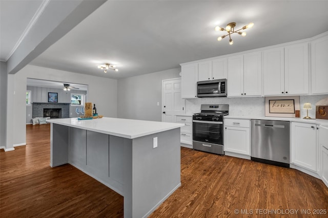 507 W Quincy St, Broken Arrow, OK 74012 - kitchen with appliances with stainless steel finishes, tasteful backsplash, a fireplace, and light countertops