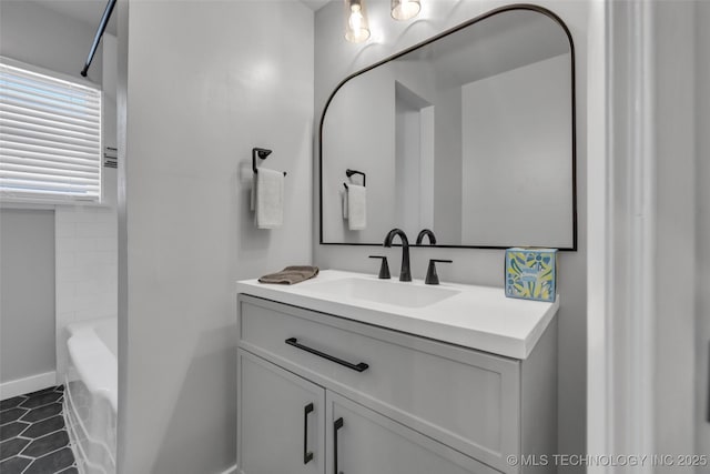 507 W Quincy St, Broken Arrow, OK 74012 - bathroom featuring vanity, a tub to relax in, baseboards, and tile patterned floors