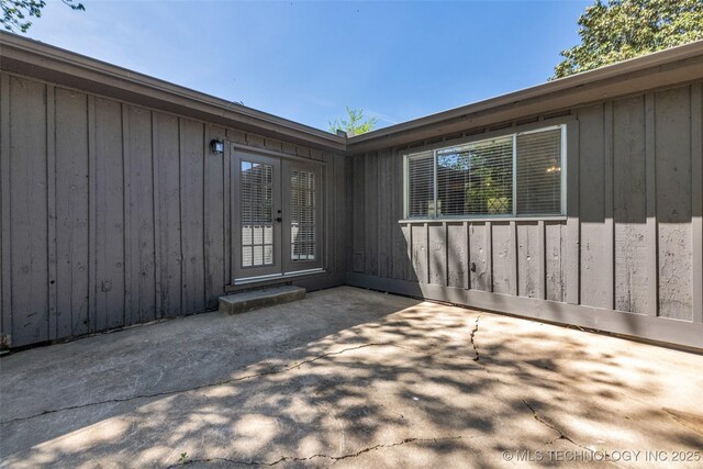 507 W Quincy St, Broken Arrow, OK 74012 - view of exterior entry with a patio area, french doors, and board and batten siding