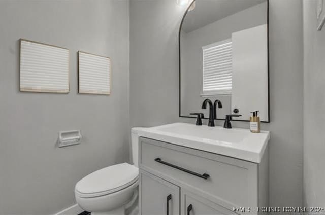 507 W Quincy St, Broken Arrow, OK 74012 - bathroom featuring vanity, toilet, and baseboards