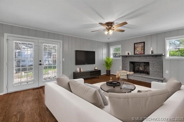 507 W Quincy St, Broken Arrow, OK 74012 - living room featuring plenty of natural light, ceiling fan, a stone fireplace, wood finished floors, and a decorative wall