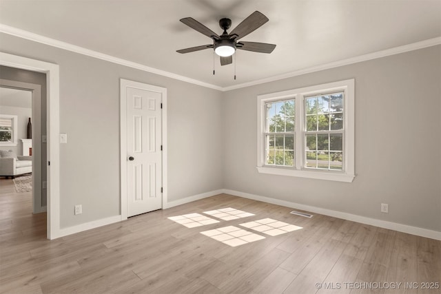 3224 S Darlington Ave, Tulsa, OK 74135 - unfurnished bedroom with baseboards, multiple windows, ornamental molding, and wood finished floors