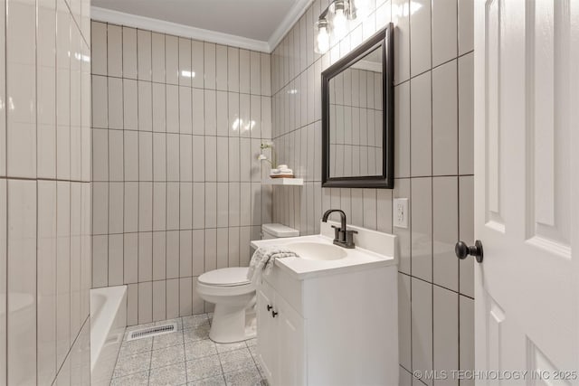 3224 S Darlington Ave, Tulsa, OK 74135 - full bath featuring toilet, tile walls, a tub to relax in, visible vents, and crown molding