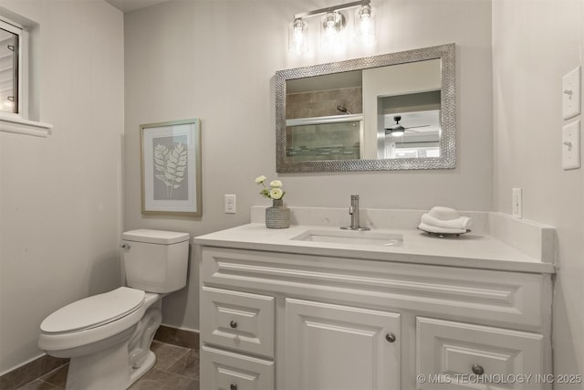 3224 S Darlington Ave, Tulsa, OK 74135 - bathroom with an enclosed shower, toilet, baseboards, ceiling fan, and vanity