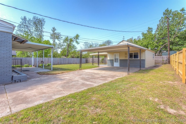 3224 S Darlington Ave, Tulsa, OK 74135 - view of yard featuring driveway, a fenced backyard, and a carport