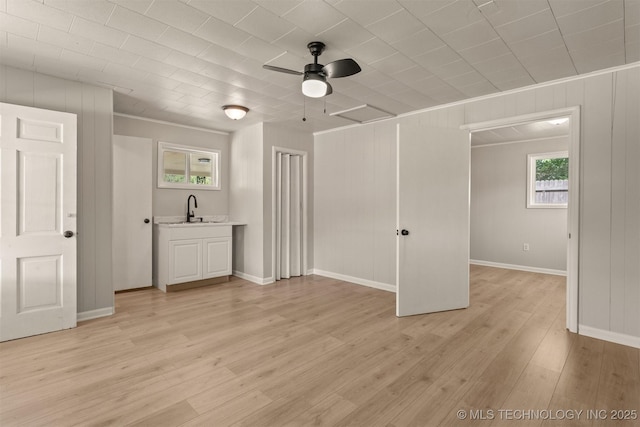 3224 S Darlington Ave, Tulsa, OK 74135 - interior space featuring a ceiling fan, baseboards, ornamental molding, a sink, and light wood-type flooring