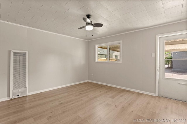 3224 S Darlington Ave, Tulsa, OK 74135 - spare room featuring a heating unit, crown molding, light wood-style floors, and ceiling fan