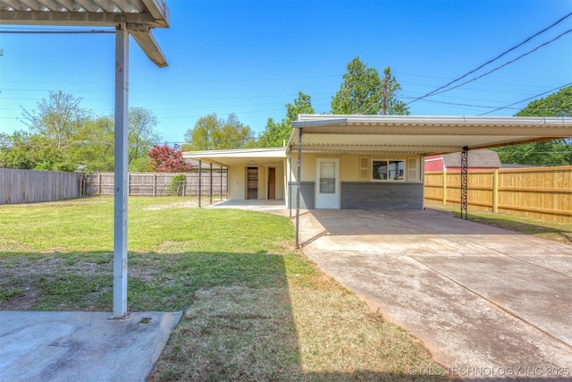 3224 S Darlington Ave, Tulsa, OK 74135 - view of front of property with a fenced backyard, concrete driveway, a carport, and a front lawn