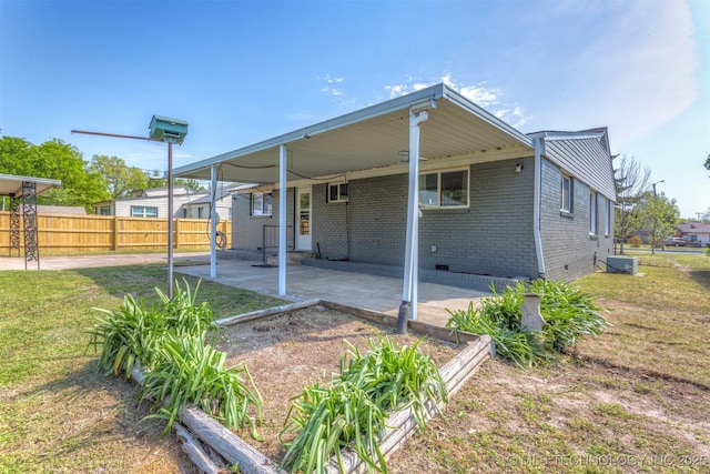 3224 S Darlington Ave, Tulsa, OK 74135 - exterior space with fence, brick siding, crawl space, an attached carport, and a lawn