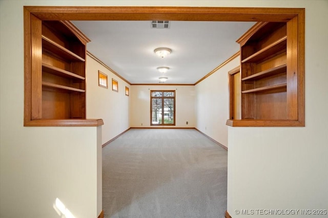 509 NE 10th St, Wagoner, OK 74467 - spare room featuring baseboards, visible vents, carpet flooring, and crown molding