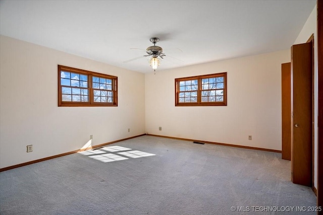 509 NE 10th St, Wagoner, OK 74467 - unfurnished room featuring a healthy amount of sunlight, carpet flooring, and baseboards