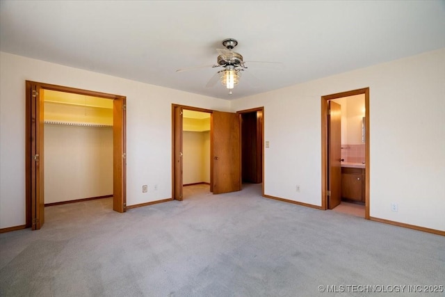 509 NE 10th St, Wagoner, OK 74467 - unfurnished bedroom featuring ensuite bathroom, a spacious closet, ceiling fan, carpet floors, and baseboards