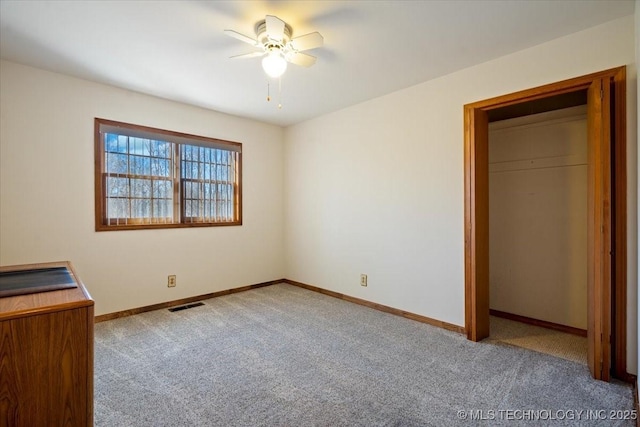 509 NE 10th St, Wagoner, OK 74467 - unfurnished bedroom with baseboards, a ceiling fan, visible vents, and carpet