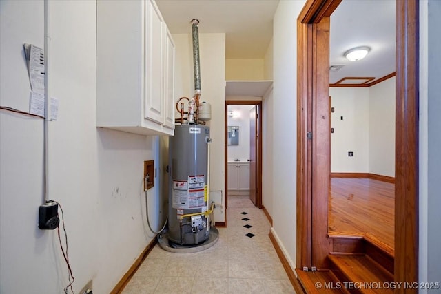 509 NE 10th St, Wagoner, OK 74467 - utility room featuring electric panel and gas water heater