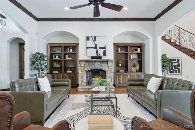 10626 S Joplin Ave, Tulsa, OK 74137 - living room featuring crown molding, recessed lighting, ceiling fan, light wood finished floors, and a stone fireplace