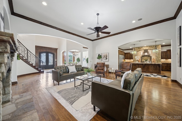 10626 S Joplin Ave, Tulsa, OK 74137 - living room with arched walkways, wood finished floors, ceiling fan, stairway, and ornamental molding