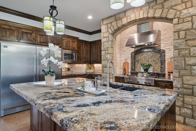 10626 S Joplin Ave, Tulsa, OK 74137 - kitchen with wall chimney exhaust hood, built in appliances, a sink, stone counters, and ornamental molding