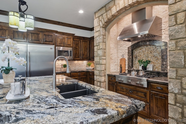 10626 S Joplin Ave, Tulsa, OK 74137 - kitchen with wall chimney exhaust hood, stainless steel appliances, a sink, dark stone counters, and tasteful backsplash