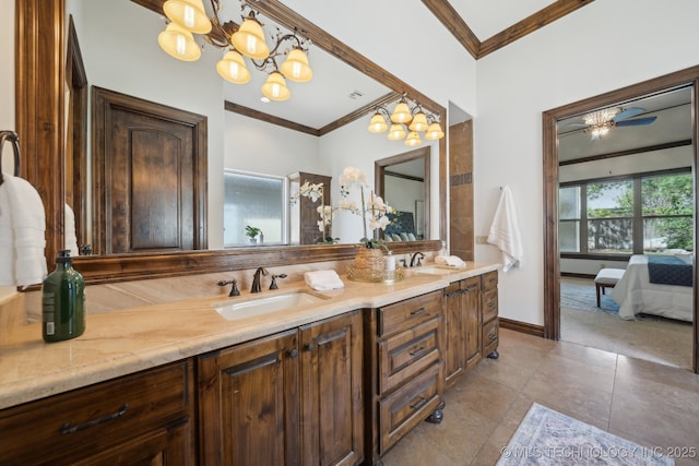 10626 S Joplin Ave, Tulsa, OK 74137 - ensuite bathroom featuring crown molding, double vanity, a chandelier, and baseboards