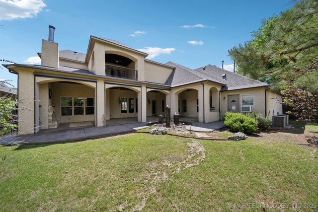 10626 S Joplin Ave, Tulsa, OK 74137 - rear view of house featuring a balcony, stucco siding, cooling unit, and a patio