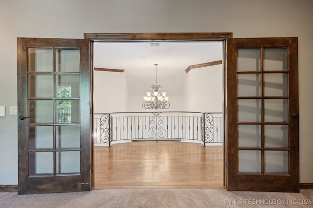 10626 S Joplin Ave, Tulsa, OK 74137 - hall with a chandelier, carpet, and wood finished floors