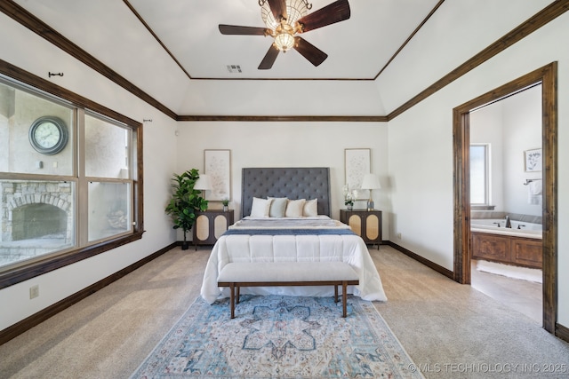 10626 S Joplin Ave, Tulsa, OK 74137 - bedroom with light colored carpet, baseboards, ensuite bath, a tray ceiling, and crown molding