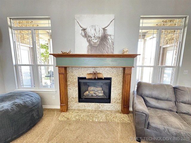 1412 Richmond Dr, Fort Gibson, OK 74434 - carpeted living area with a glass covered fireplace, a wealth of natural light, and baseboards