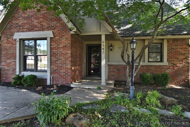 6903 E 63rd St, Tulsa, OK 74133 - view of exterior entry featuring brick siding