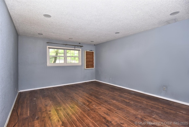 6903 E 63rd St, Tulsa, OK 74133 - empty room featuring a textured ceiling, wood-type flooring, and baseboards