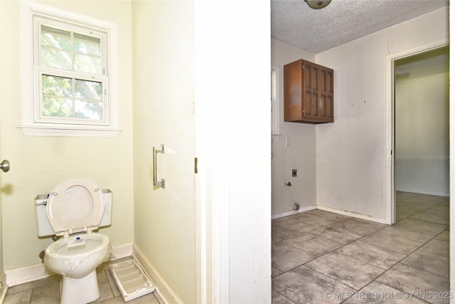 6903 E 63rd St, Tulsa, OK 74133 - bathroom featuring a textured ceiling, toilet, tile patterned floors, and baseboards