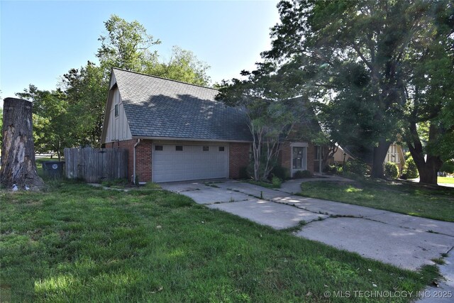 6903 E 63rd St, Tulsa, OK 74133 - view of front facade with brick siding, concrete driveway, and a shingled roof