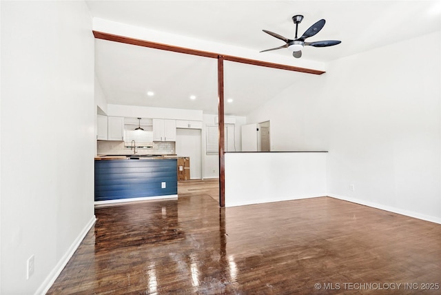 unfurnished living room featuring wood finished floors, ceiling fan, baseboards, lofted ceiling, and recessed lighting