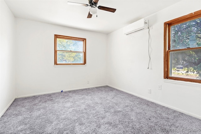 unfurnished room with ceiling fan, baseboards, an AC wall unit, and carpet flooring