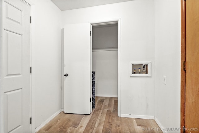 laundry room with baseboards, wood finished floors, hookup for a washing machine, and laundry area