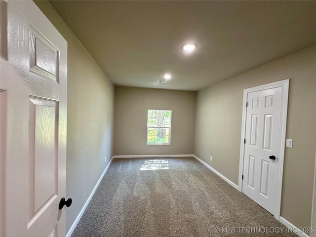 empty room featuring baseboards, carpet flooring, and recessed lighting