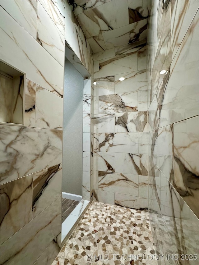 interior space featuring a tile shower