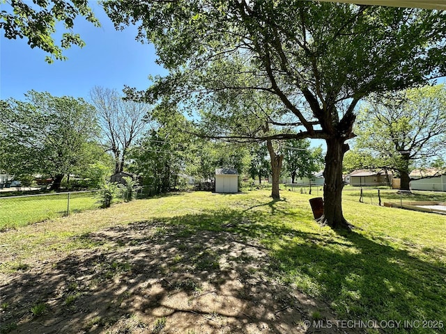 view of yard featuring a fenced backyard, an outbuilding, and a storage shed