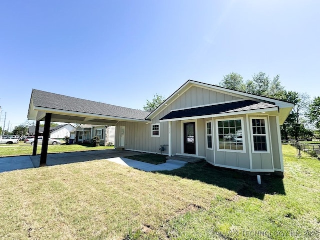 view of front of home featuring a front lawn, driveway, and board and batten siding