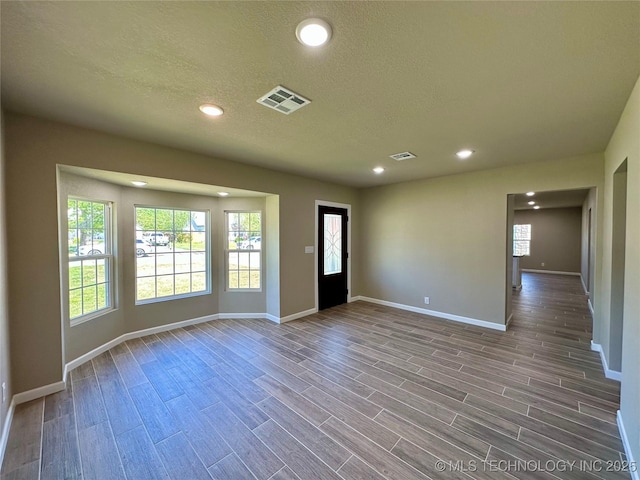 entrance foyer with visible vents, a wealth of natural light, baseboards, and recessed lighting