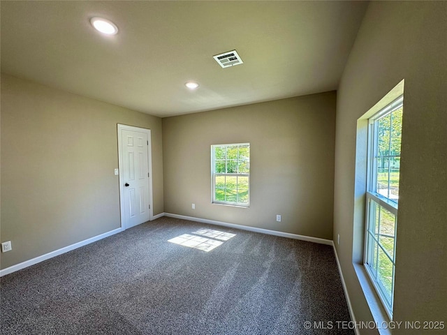 unfurnished room featuring baseboards, carpet flooring, visible vents, and recessed lighting